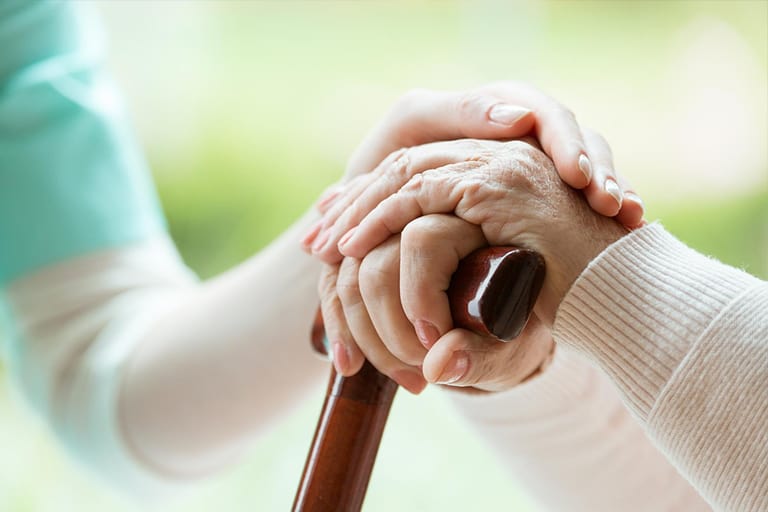 Caregiver talking to elderly couple